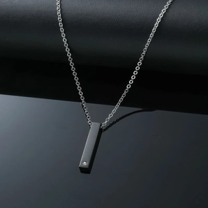 Detail of black rectangular pendant necklace with a small inset zircon stone