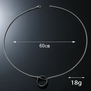 Minimalist silver chain necklace with ring pendant 60cm length 18g weight on black surface