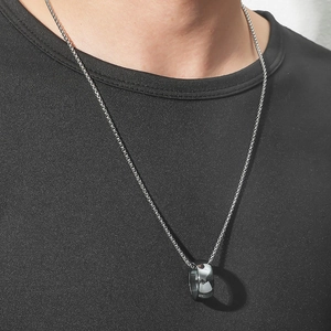 Minimalist silver ring pendant necklace for men worn on a black t-shirt
