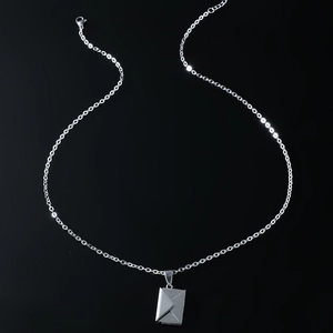 Polished silver envelope pendant necklace with creative letter design on black background