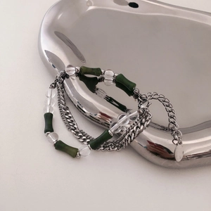 New Chinese style green bamboo bead bracelet with layered silver chains on a metal tray