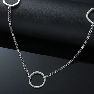 Detailed macro view of silver titanium steel curb chain necklace with metal circles