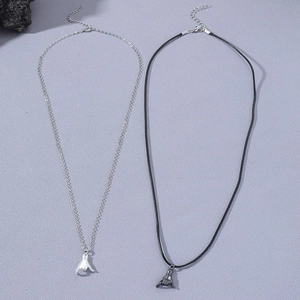 Detail of silver chain and black cord necklaces with matching hand gesture pendants