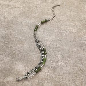 Close-up of green bamboo beads and stainless steel chain with S.Steel hallmark tag