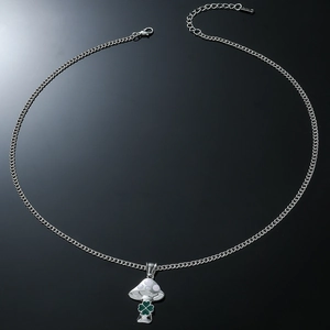 Chic mushroom pendant necklace with clover detail on silver chain over black background