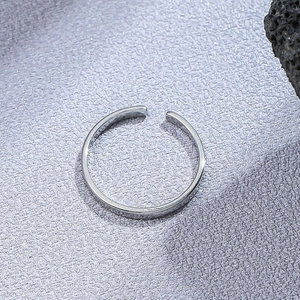Minimalist adjustable silver titanium steel open ring on a textured purple background