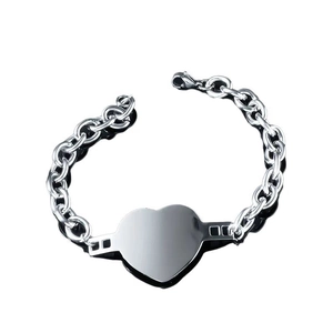 Minimalist silver heart tag chain bracelet with chunky links on a white background
