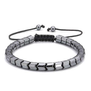 Close-up of gunmetal arrow-shaped hematite beads on a black adjustable woven bracelet
