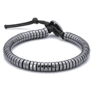 Detail of woven hematite bead bracelet with grey metallic luster on a white background