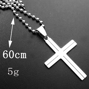 Detail of 60cm ball chain cross necklace pendant weighing 5g on black surface
