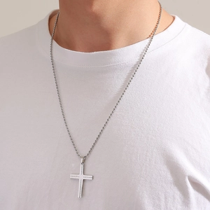 Men's polished stainless steel cross pendant necklace with classic ball chain on white tee