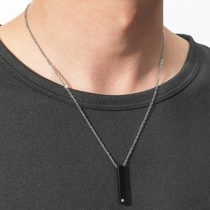 Minimalist black rectangle pendant necklace with crystal inlay for men on a black T-shirt