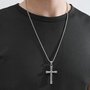Minimalist silver cross pendant necklace on model with street style box chain