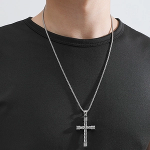 Men's minimalist silver cross pendant necklace with box chain on black t-shirt
