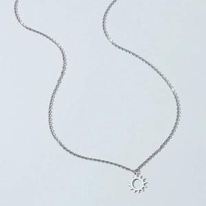 Minimalist silver sun pendant necklace for women with hollow sun design on cross chain