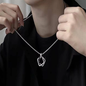 Silver geometric interlocking ring pendant necklace worn on a black shirt for men