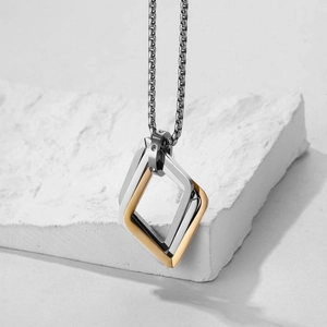 Detail of interlocking geometric diamond-shaped pendants in gold and silver finish