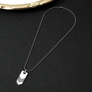 Detail of silver geometric arrow pendant with black V-grooves on stainless steel bead chain