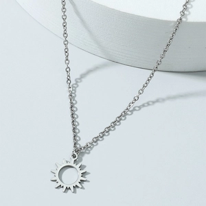 Minimalist silver sun pendant necklace featuring a hollow sunburst on a delicate cable chain