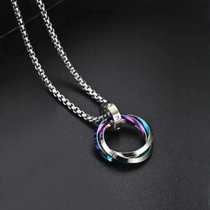 Macro view of interlocking triple rings necklace with iridescent and silver metal finish