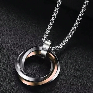 Macro shot of interlocking triple ring pendant necklace with crystal accents and box chain