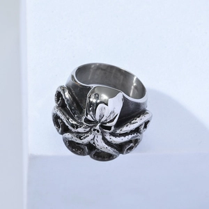 Vintage octopus ring in stainless steel with detailed tentacles on white pedestal