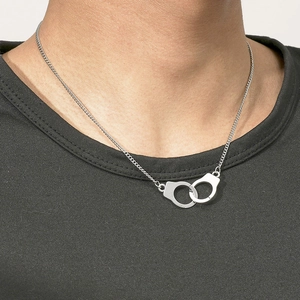 Men's silver stainless steel handcuff necklace with double interlocking pendant on model