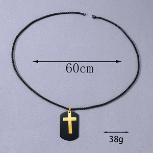 Detail view of black dog tag necklace with golden cross including weight and length specs