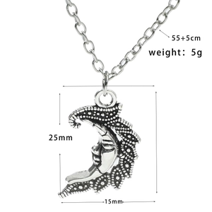 Detail of vintage silver moon pendant with embossed texture and chain measurements