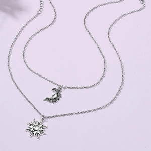 Vintage layered silver necklace featuring celestial sun and moon engraved pendants