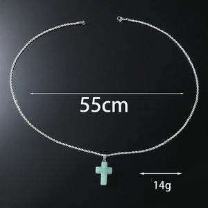 Detailed view of silver rope chain with green stone cross pendant, 55cm and 14g