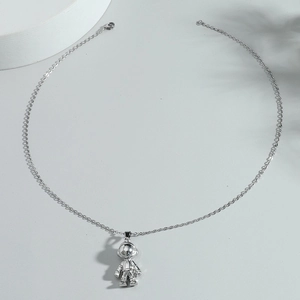 Detail of silver astronaut pendant with fine metal chain and secure lobster clasp