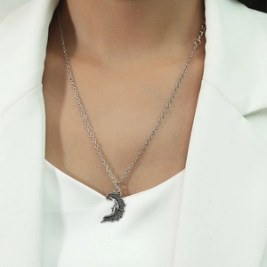 Vintage silver crescent moon pendant necklace with face detail on a fine silver-tone chain
