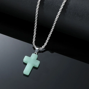 Detail of light green crystal cross pendant with a silver twist rope chain for men