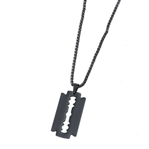 Detailed macro view of a matte black razor blade pendant on a punk style link chain