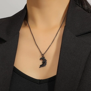 Macro detail of gothic black crescent moon pendant necklace with inset black crystals