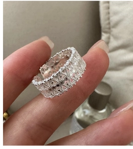 Close-up of S925 sterling silver lace ring featuring intricate hollow floral patterns
