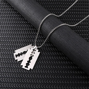 Macro shot of silver razor blade pendant necklaces with gothic steampunk metal box chains