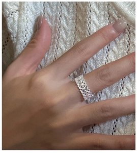 Detail of S925 sterling silver lace ring with micro-pave crystals on female hand