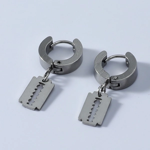 Close-up of gothic stainless steel razor blade hoop earrings with matte brushed finish