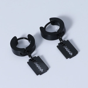 Detail view of black punk razor blade earrings featuring stainless steel metal finish