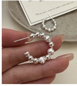 Detail of S925 sterling silver beaded C-shape earrings with S925 hallmark engraving