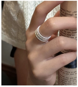 Close-up of S925 sterling silver hollow lace ring with sparkling cubic zirconia on finger