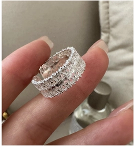 Close-up of S925 sterling silver ring with vintage lace pattern and adjustable open band