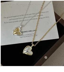 Detail of 925 silver matte heart necklace with gold and silver color blocking style