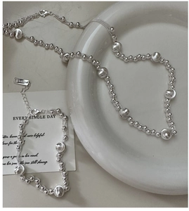 Detailed macro view of S925 sterling silver bead necklace with engraved hallmark