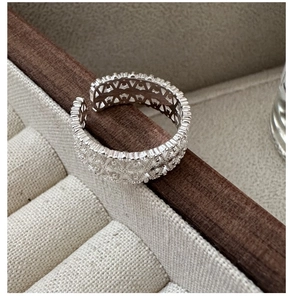 Macro view of adjustable S925 silver lace ring featuring intricate geometric hollow patterns