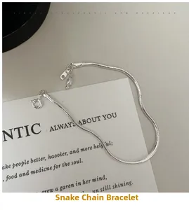Detailed close-up of S925 sterling silver snake bone bracelet on a white aesthetic card