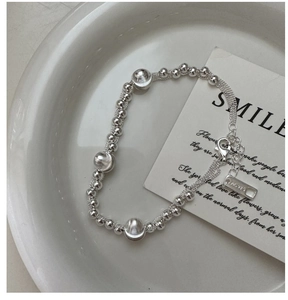 Detailed shot of S925 sterling silver beaded bracelet with lobster clasp and AG925 tag