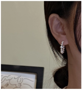 Close-up of S925 sterling silver beaded hoop earring showing mirror-like metallic finish